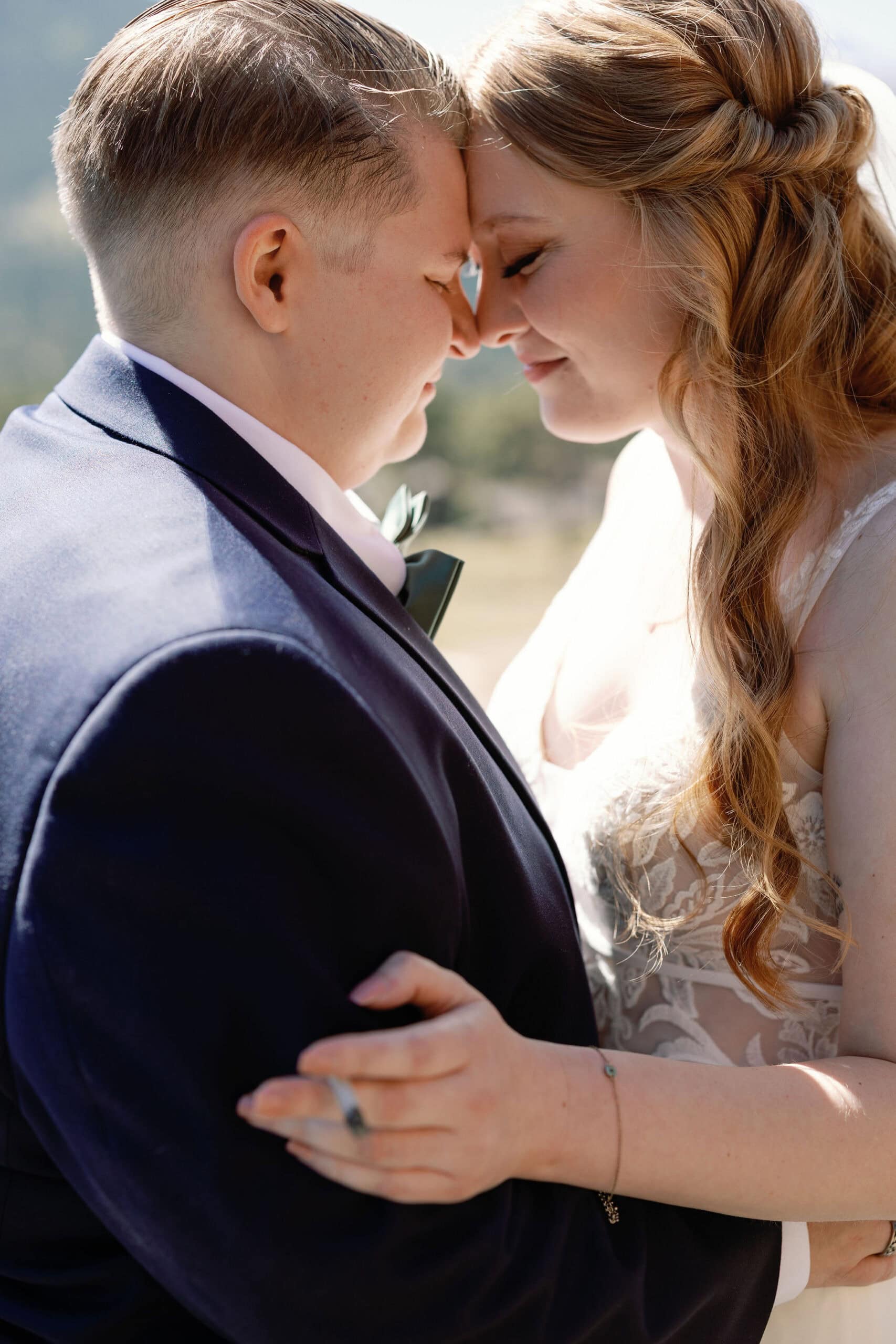 lgbtq couple shares a joint before they get married in estes park colorado during their cannabis friendly colorado wedding