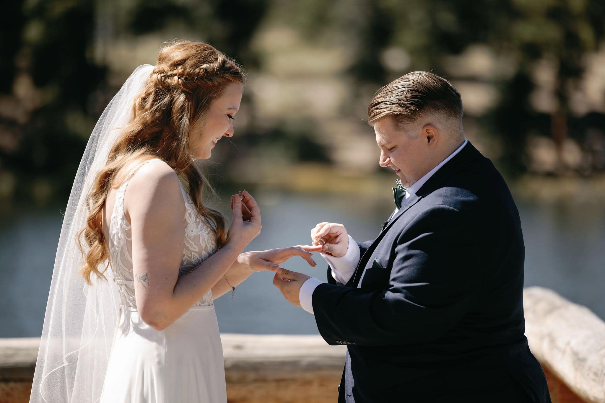 LGBTQ+ couple exchange rings at their Sprague Lake wedding in Rocky Mountain National Park Colorado.