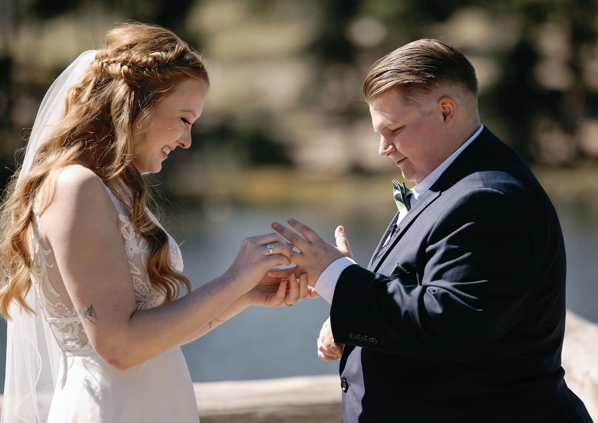 LGBTQ+ couple exchange rings at their Sprague Lake wedding in Rocky Mountain National Park Colorado.