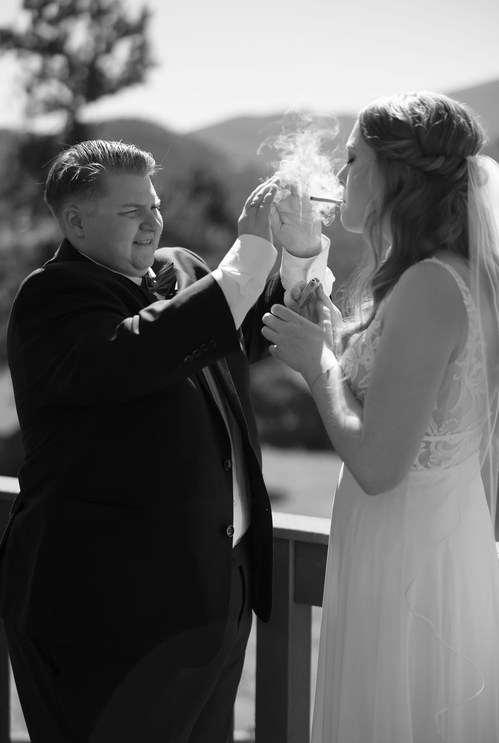 lgbtq couple shares a joint before they get married in estes park colorado during their cannabis friendly colorado wedding