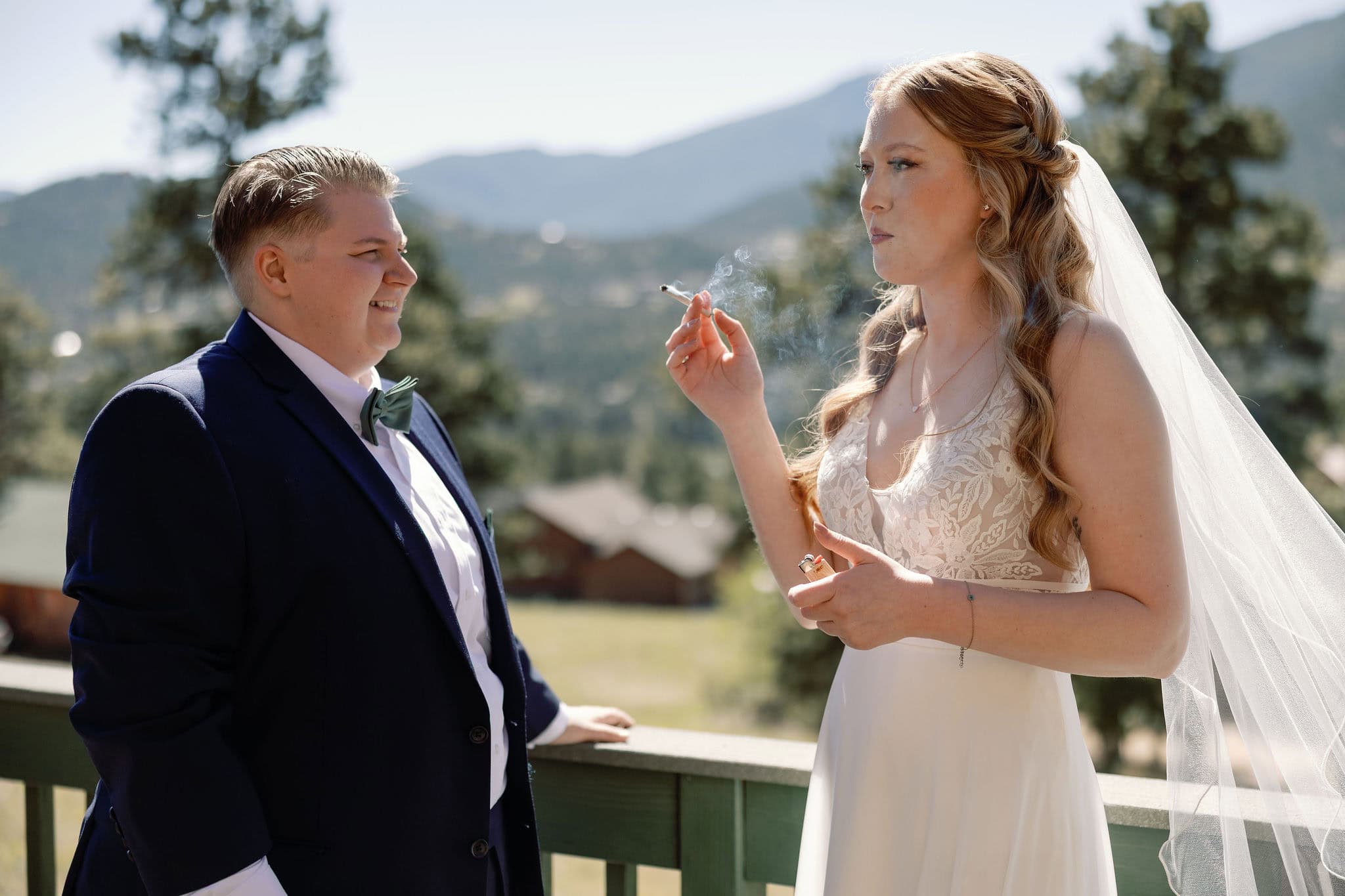 lgbtq couple shares a joint before they get married in estes park colorado during their cannabis friendly colorado wedding