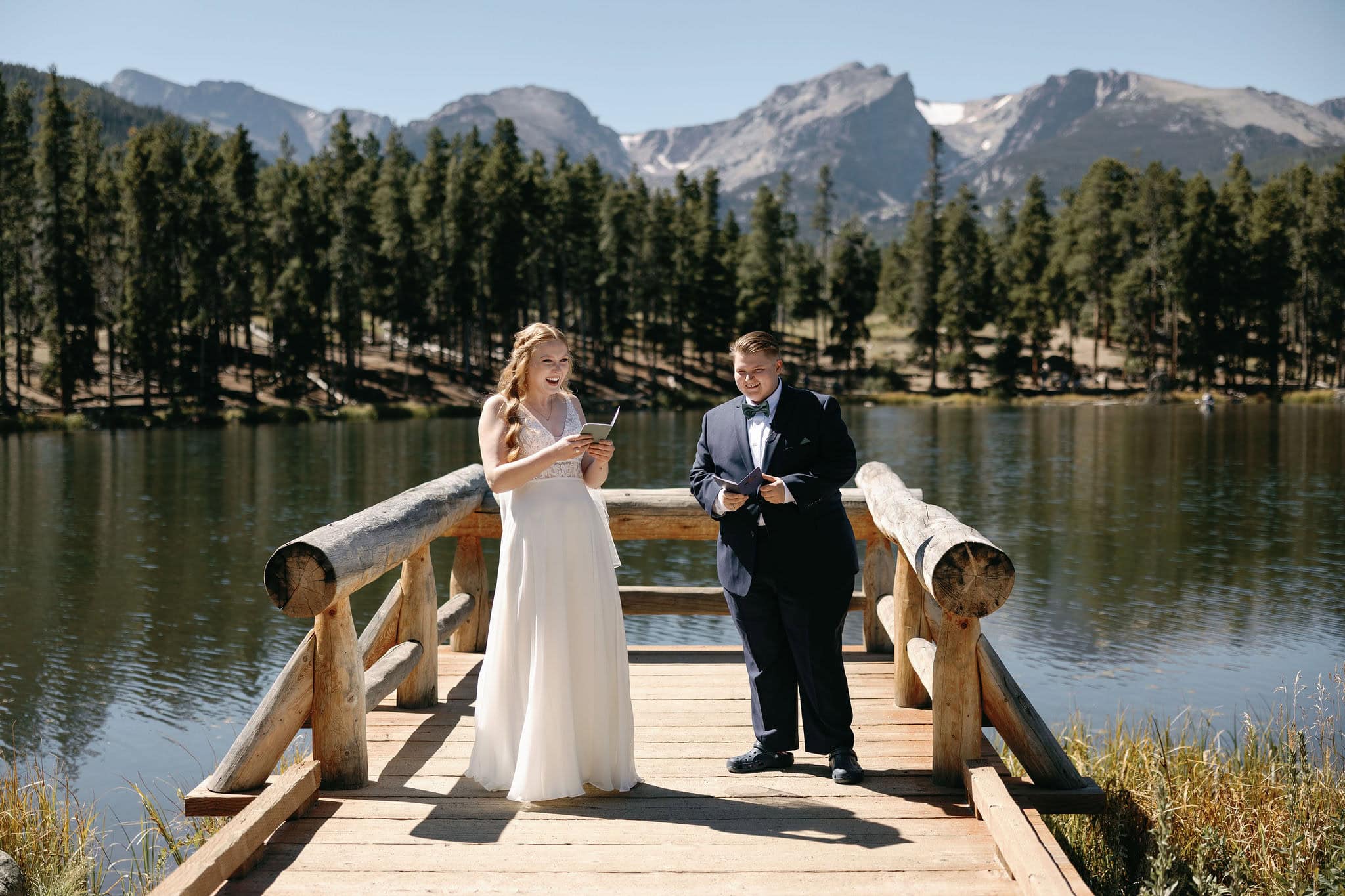 LGBTQ+ Wedding at Sprague Lake in Rocky Mountain National Park Colorado. Two Brides having a romantic lakeside Colorado wedding