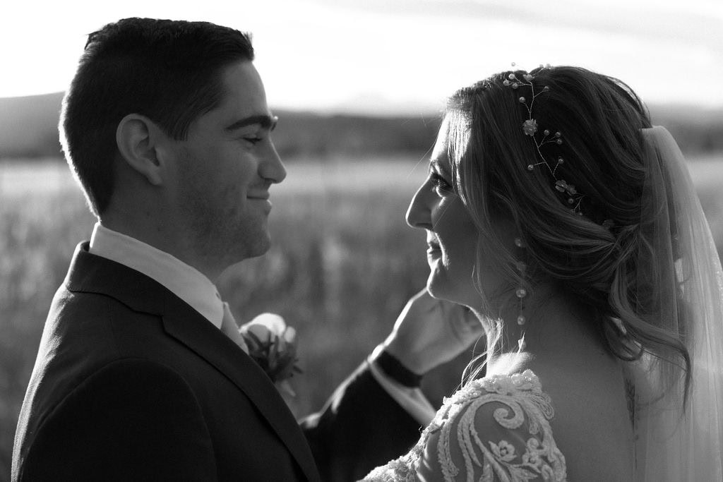 Bride and Groom Portraits at their Shupe Homestead Wedding outside in a field at sunset near boulder colorado