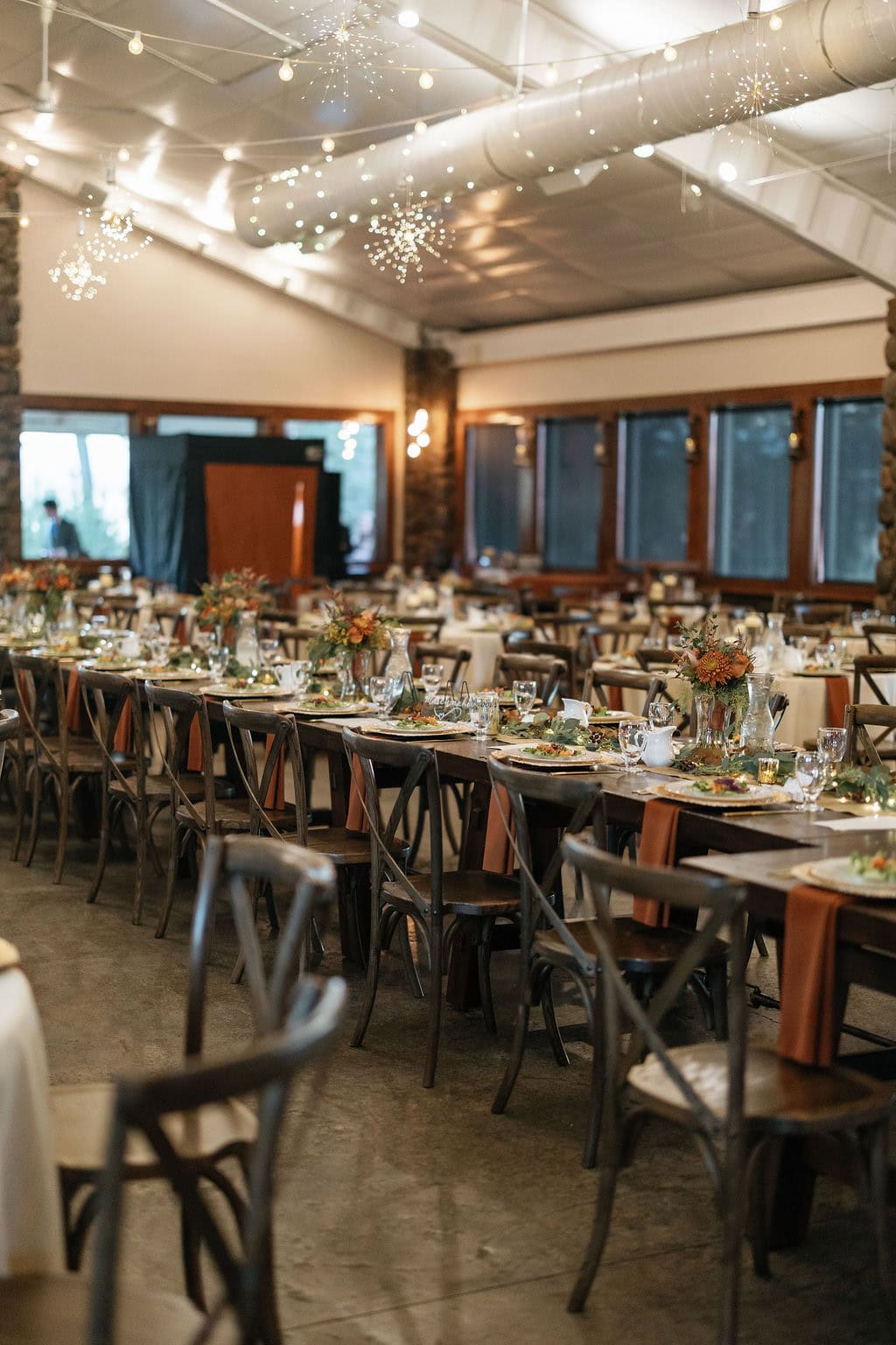 Shupe Homestead Wedding Reception Set Up and Details at a gorgeous fall wedding with hanging sparkling lights and warm tones in the details