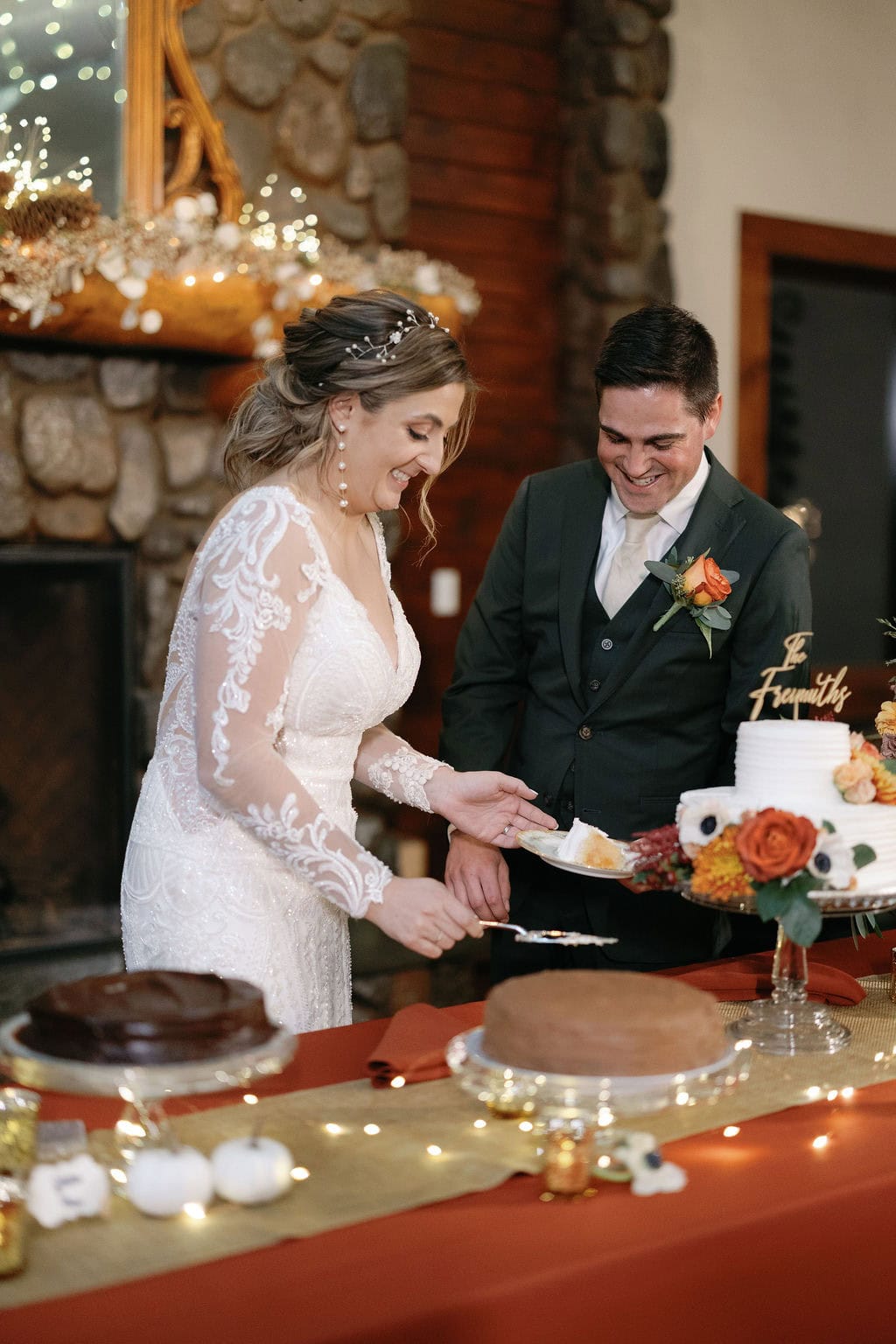 Bride and groom cut the cake and kiss at their fall wedding in boulder colorado