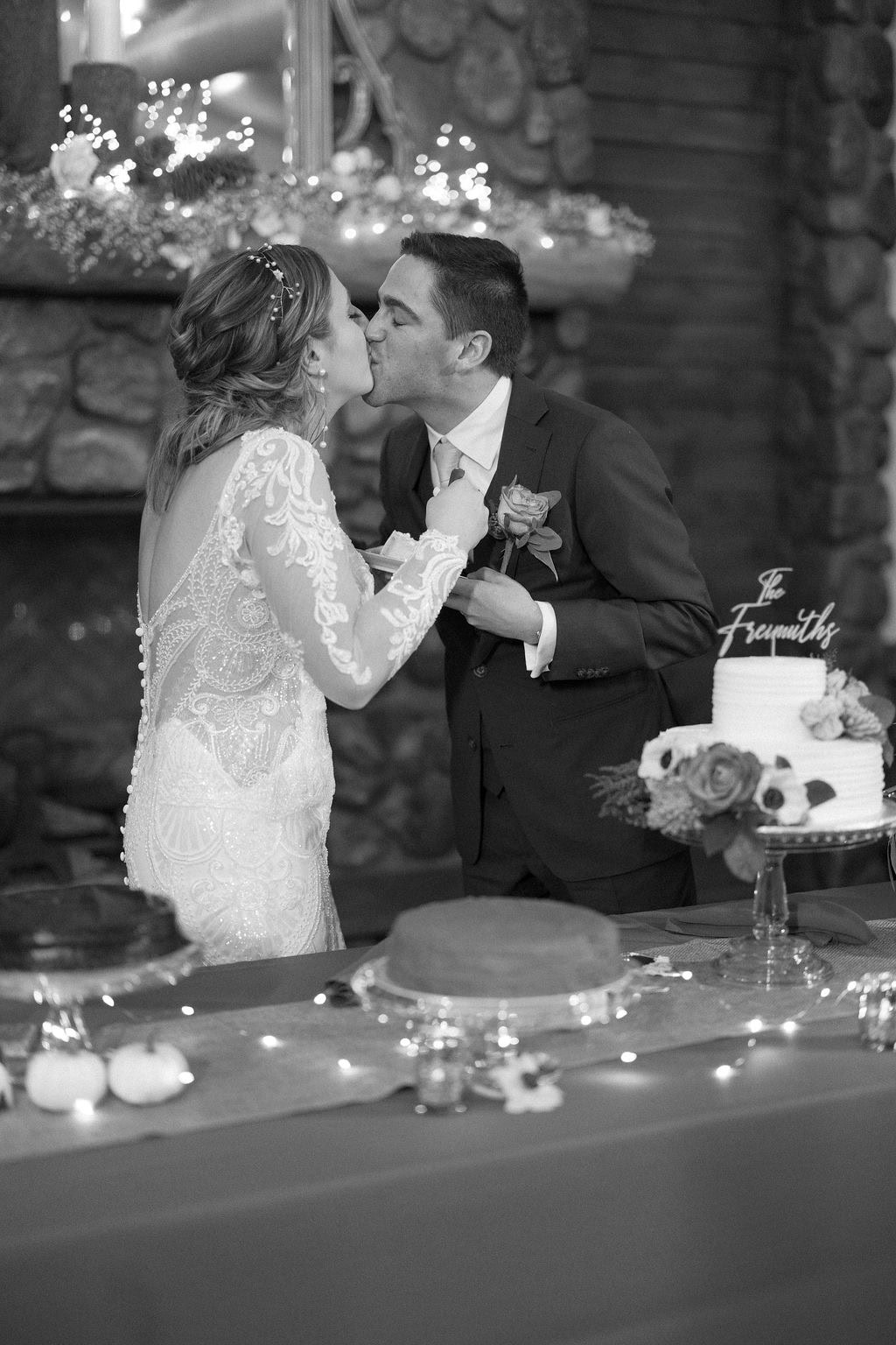 Bride and groom cut the cake and kiss at their fall wedding in boulder colorado