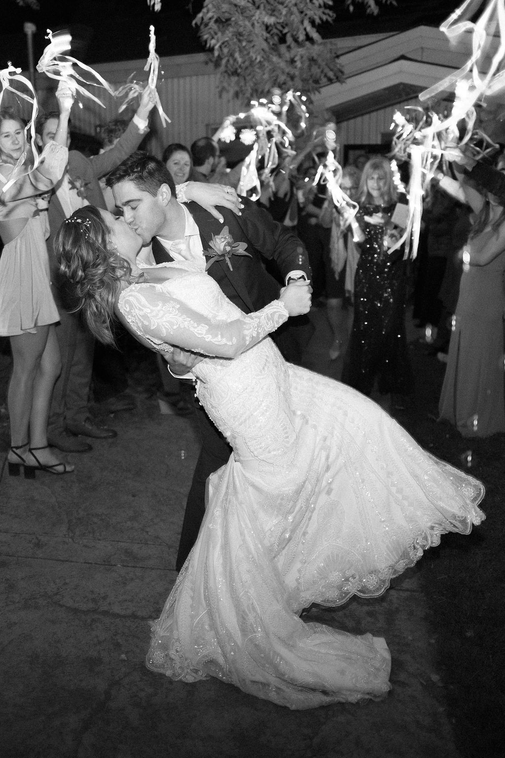 Bride and groom kiss during their wedding exit at their Shupe Homestead Wedding