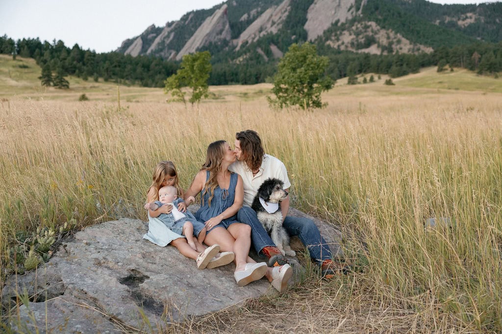 Sunrise family portraits at chautauqua park in the summertime, family sitting on the rock together