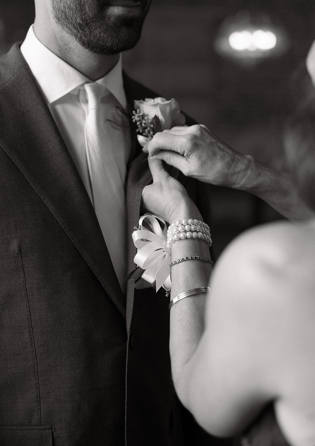 Groom gets his bout pinned on by his mom at bigsby's folly just before the start of the ceremony