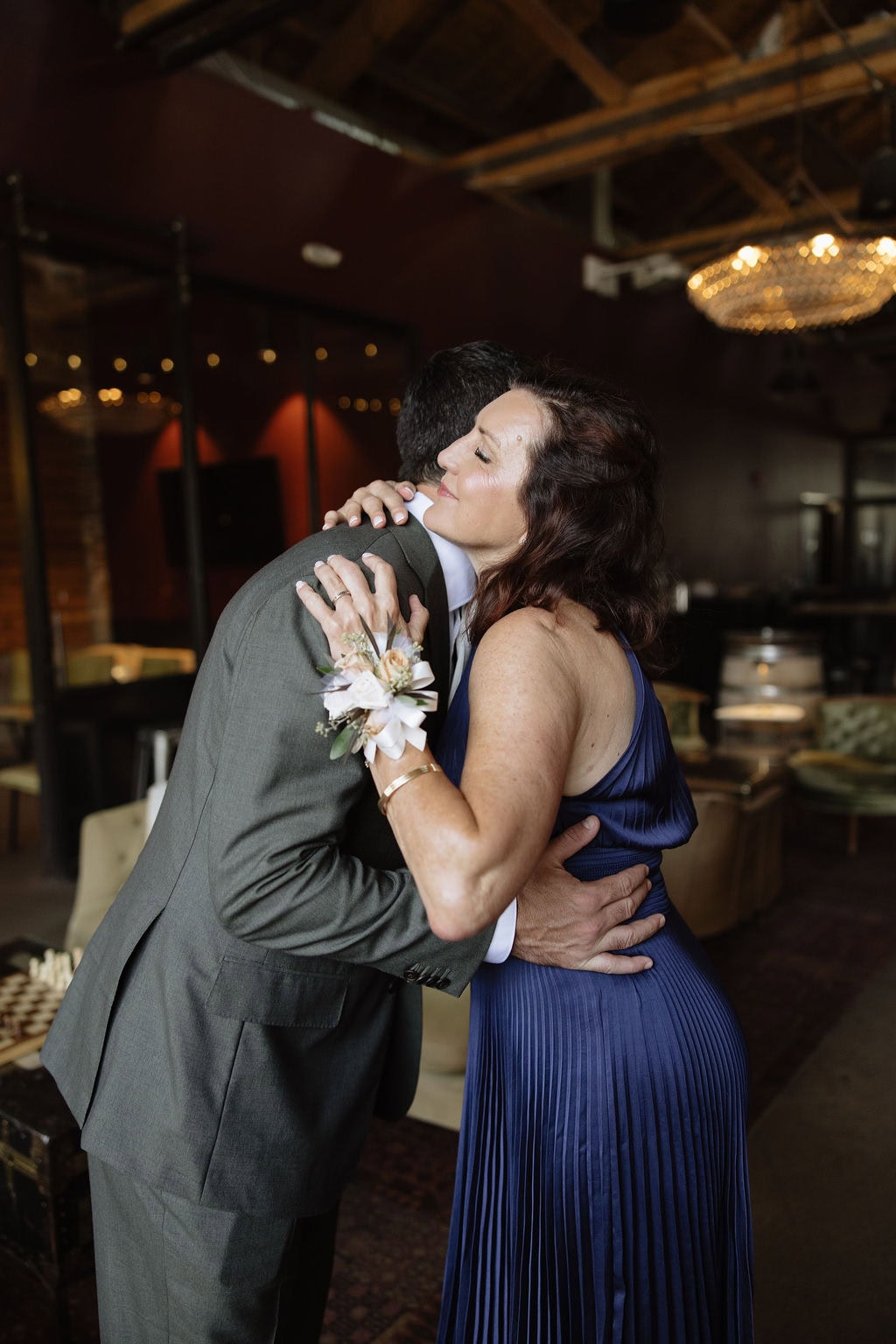 Groom gets his bout pinned on by his mom at bigsby's folly just before the start of the ceremony