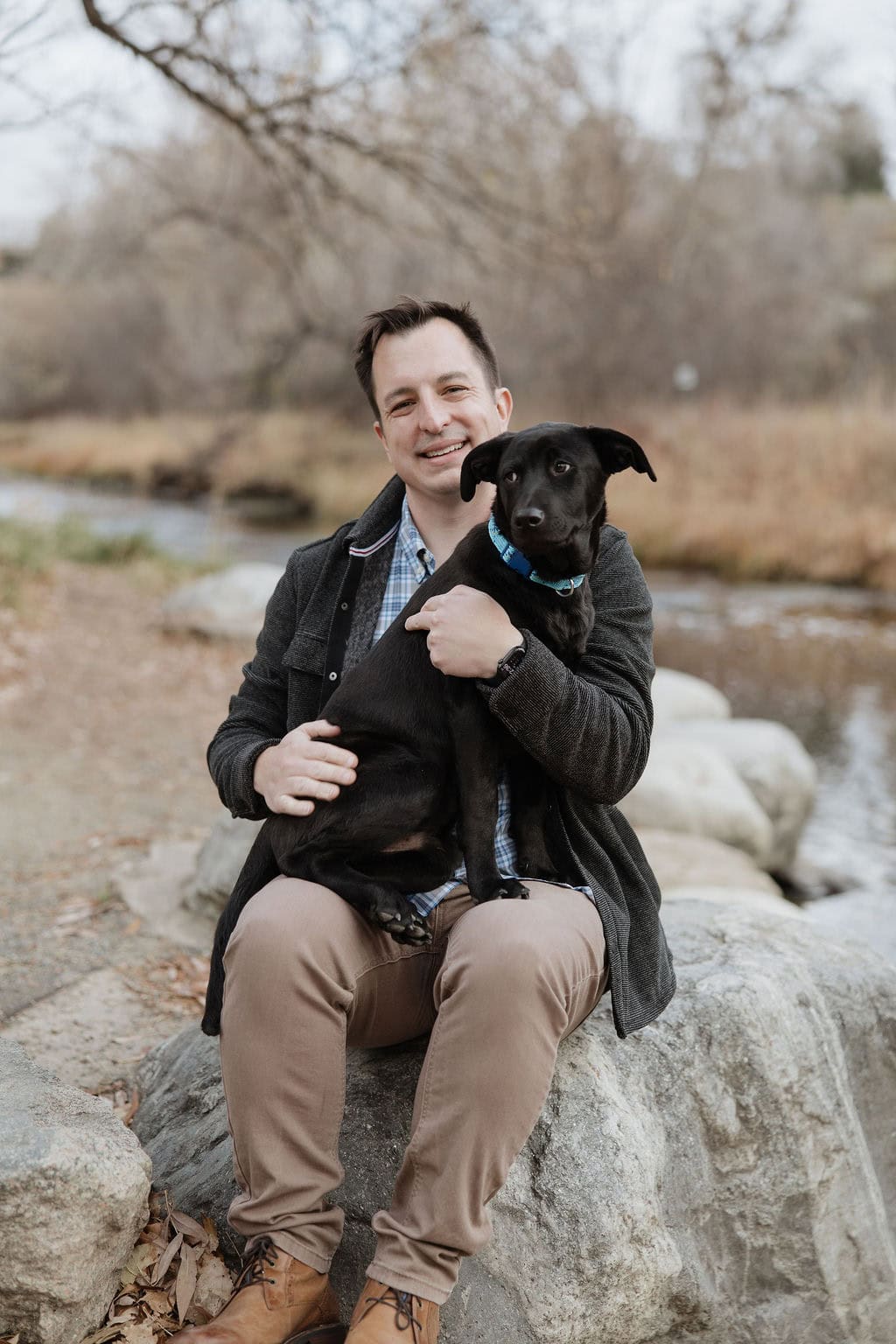 Photo of man with his dog at his pet portrait session in late november at anderson park in wheat ridge colorado