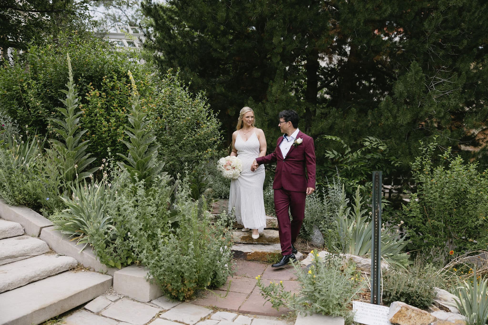 Bride and groom walk through the gardens at grant humphrey's mansion wedding 