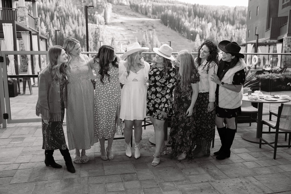 Girls pose for a photo with ski run backdrop at Wedding welcome party on the back patio at Kindred Resort in Keystone Colorado. 