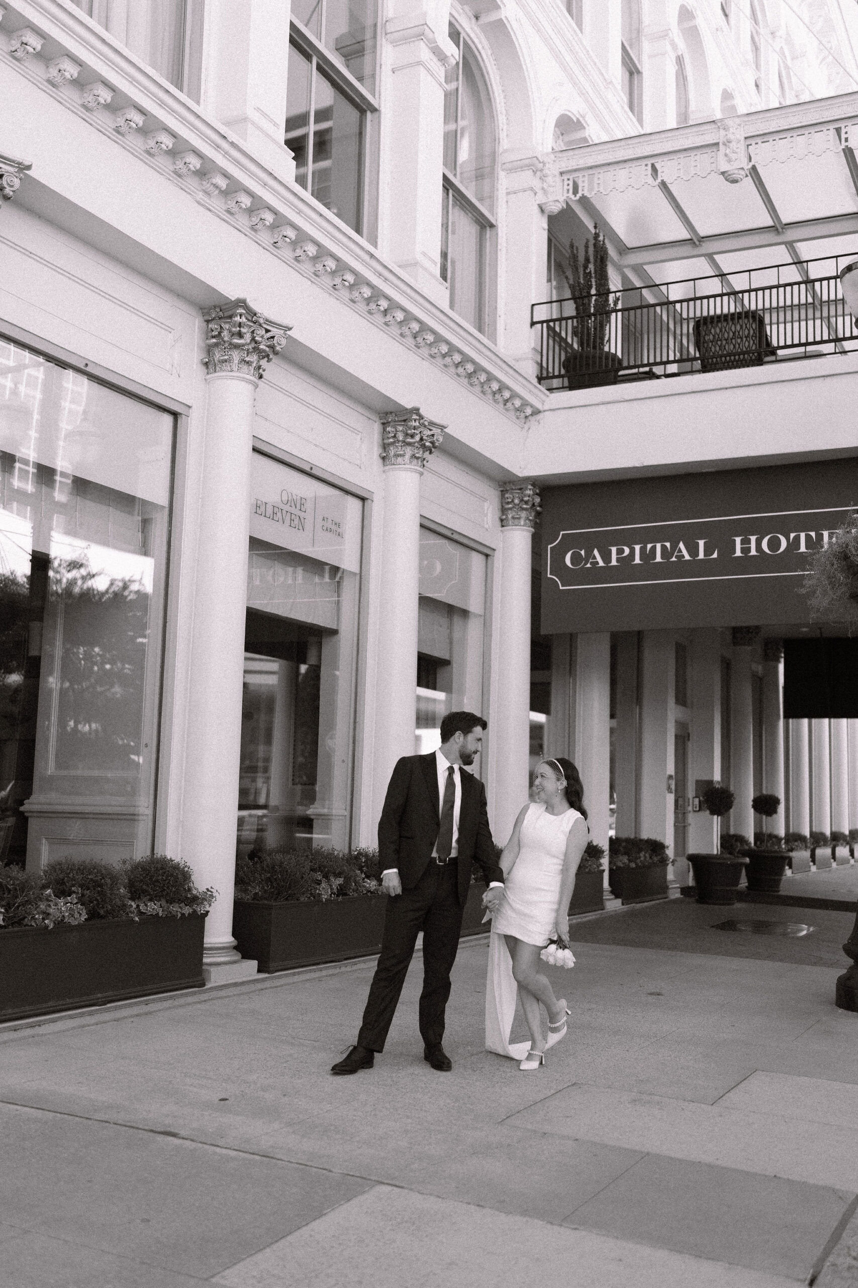 Couple leaving for their wedding outside of The Capital Hotel in Little rock