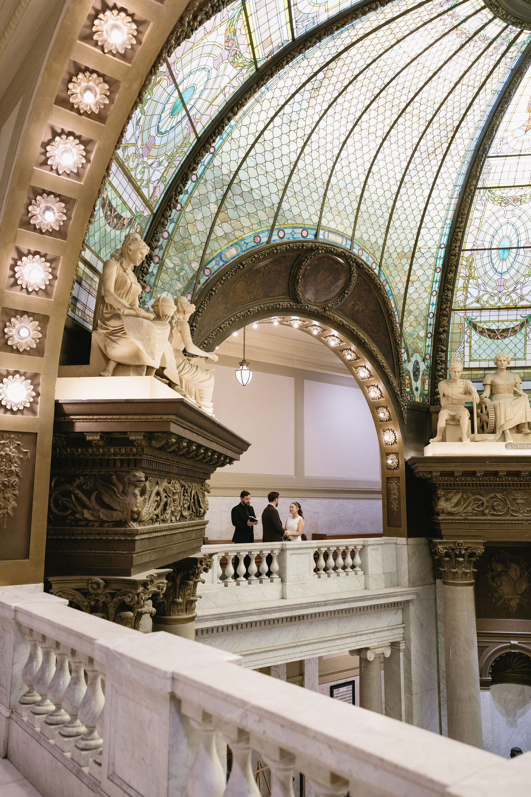 Stunning little rock courthouse wedding ceremony under stained glass dome. 