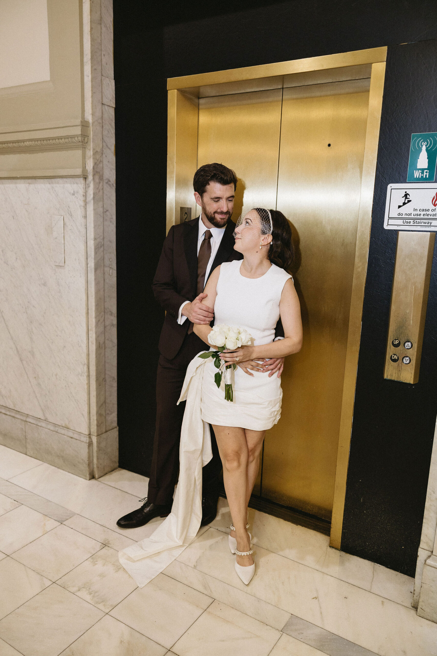 Little Rock Arkansas Courthouse Wedding Portraits of bride and groom in front of elevator doors