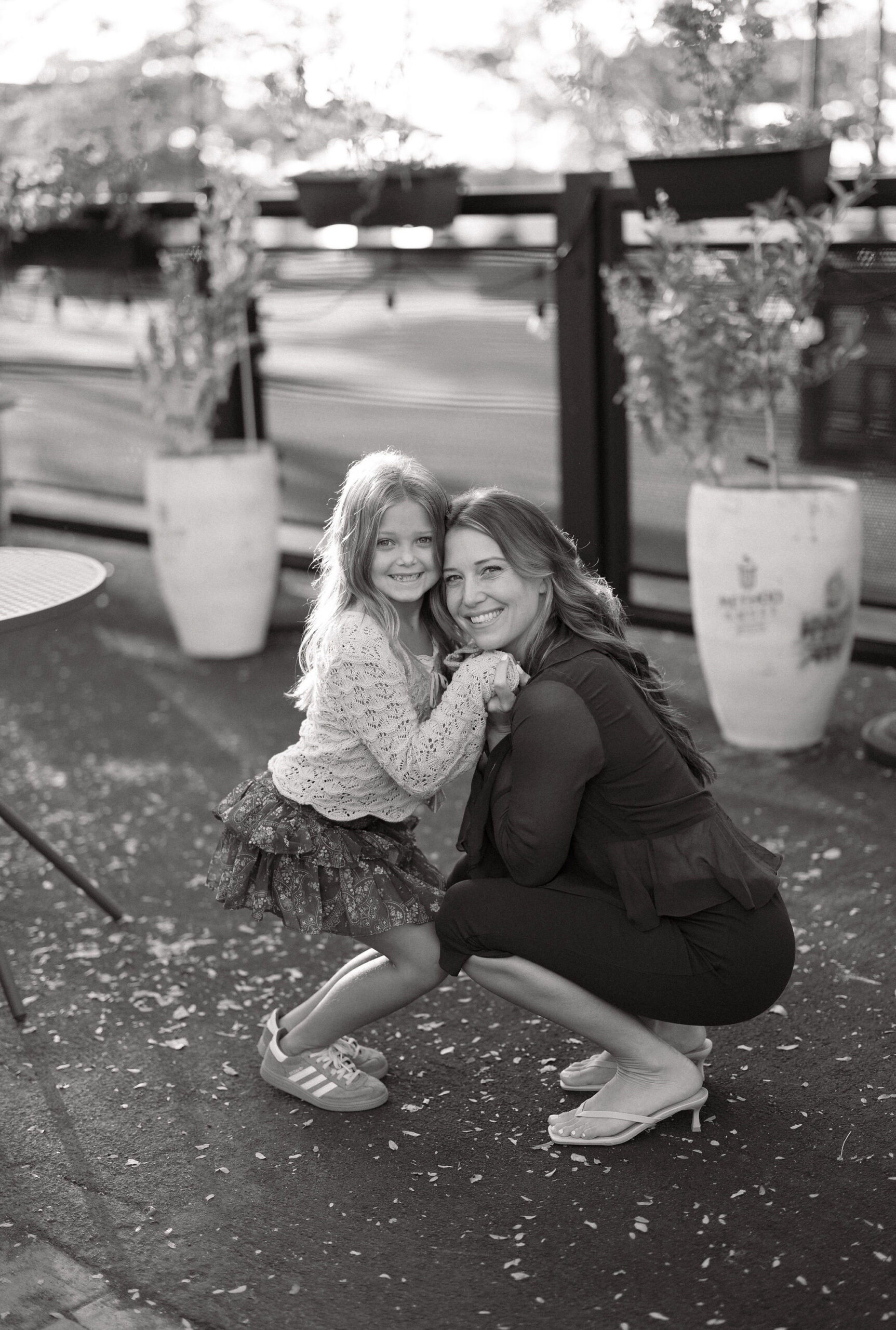 Mom and daughter outside in olde town arvada square
