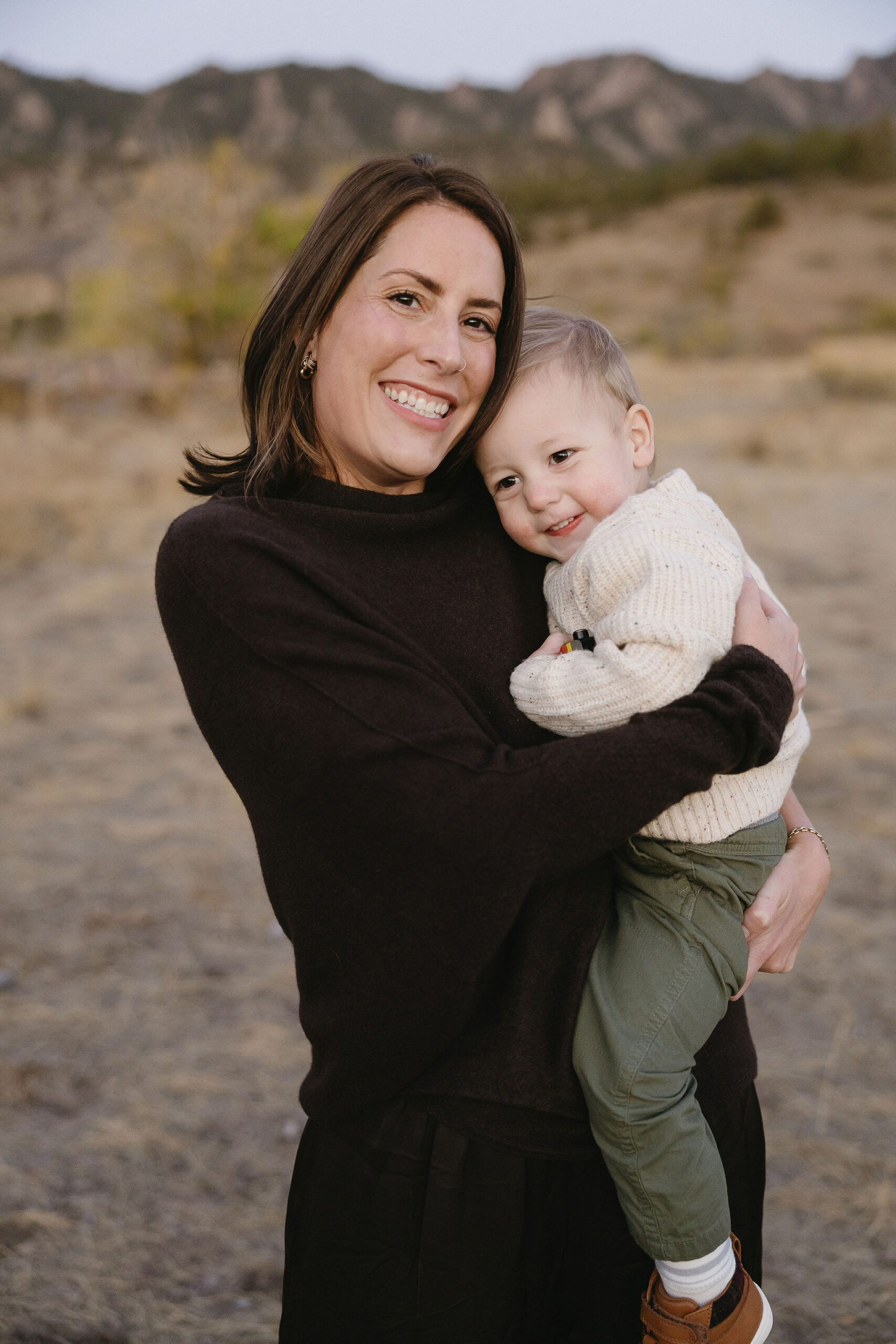 mom cuddles with her son at their south mesa boulder family session
