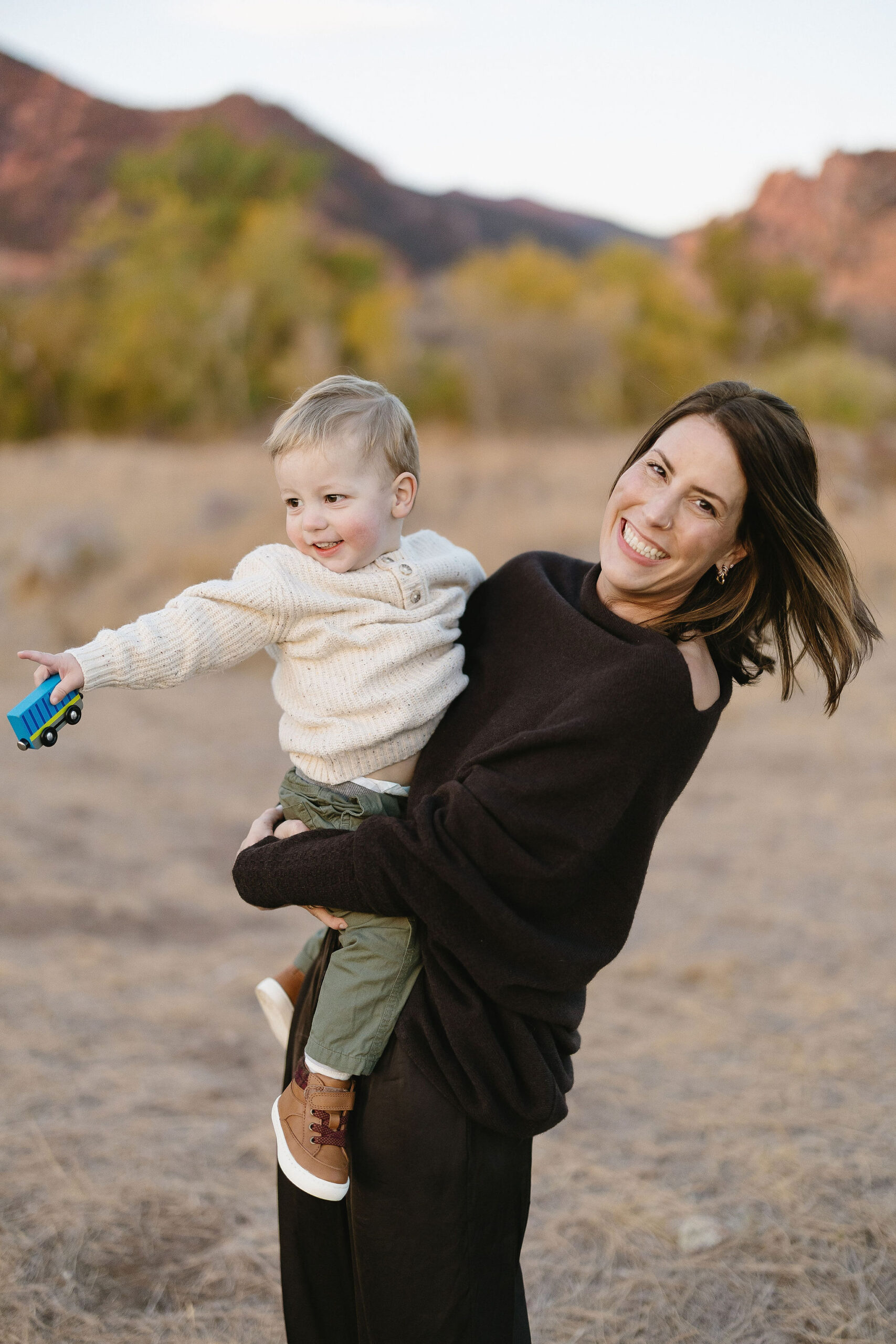 mom laughs with her son at their south mesa boulder family session