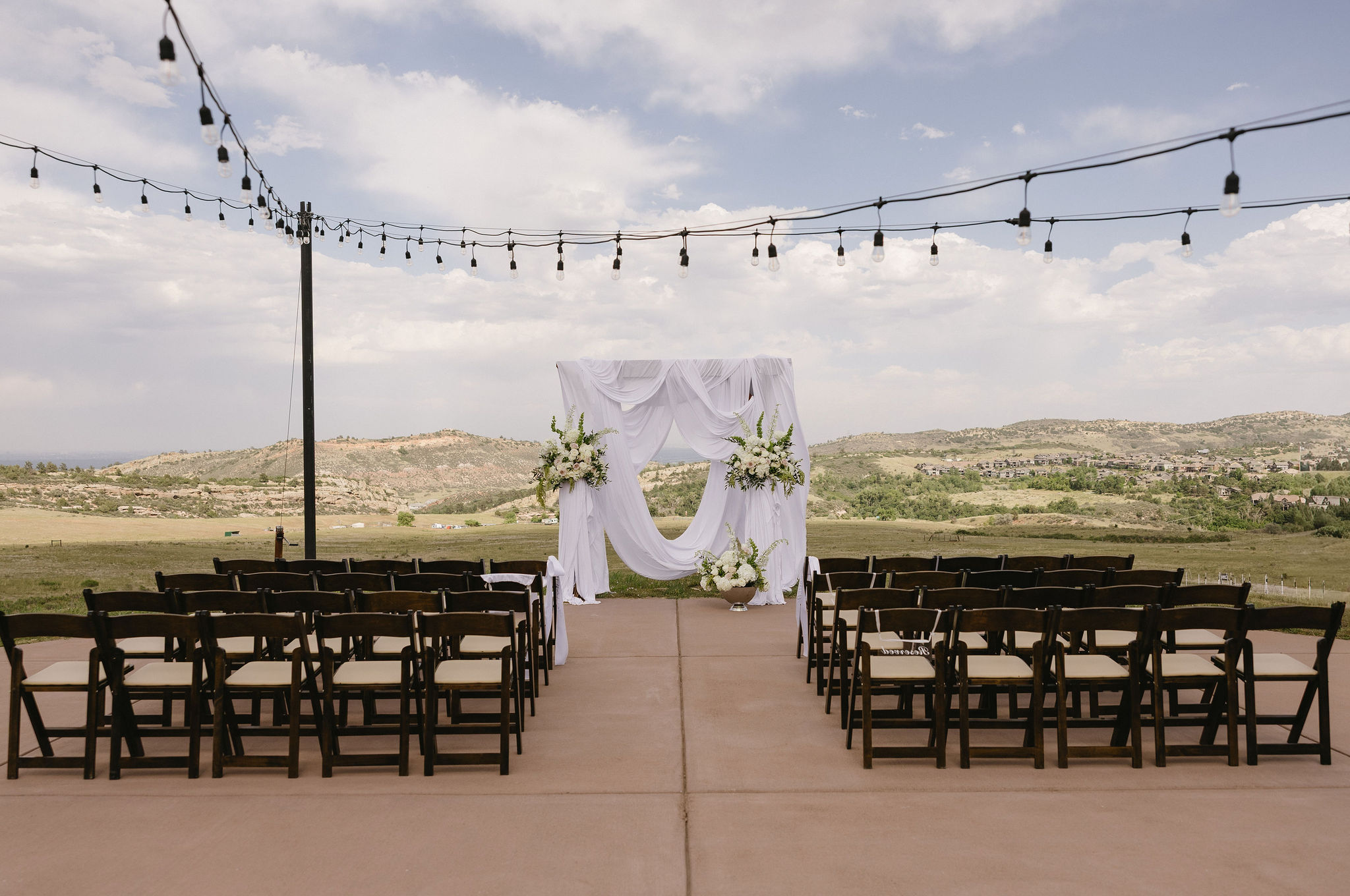 Wedding Ceremony set up at The Fort Restaurant in Morrison, Co. It overlooks the foothills and is a stunning spot for a denver area wedding