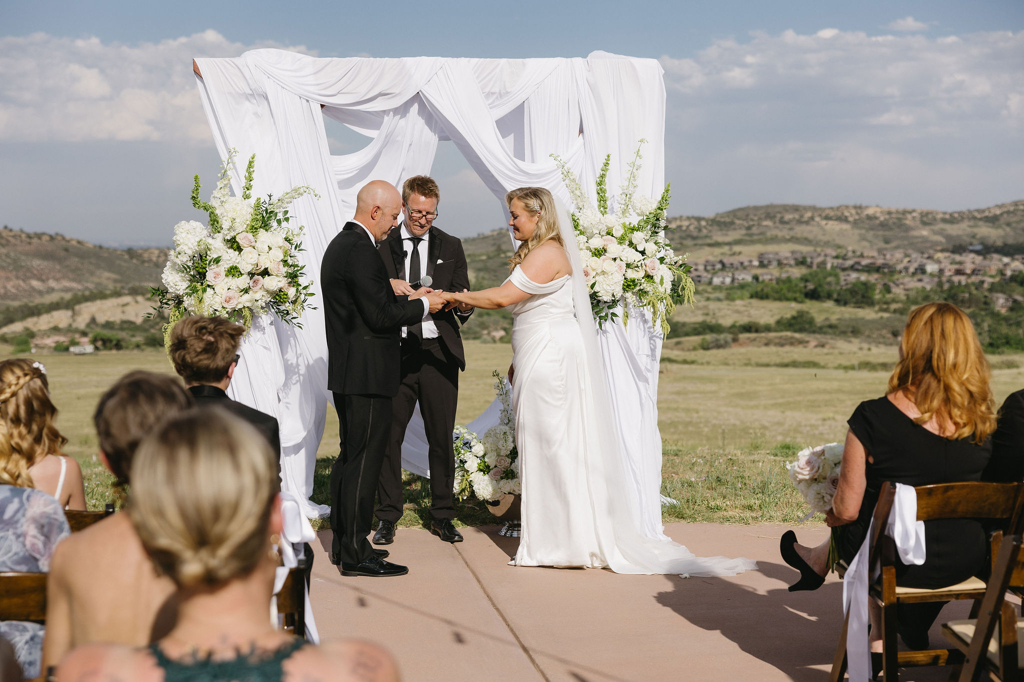 Romantic and Bright wedding ceremony on the helipad outside of The Fort Morrison Colorado Restaurant 