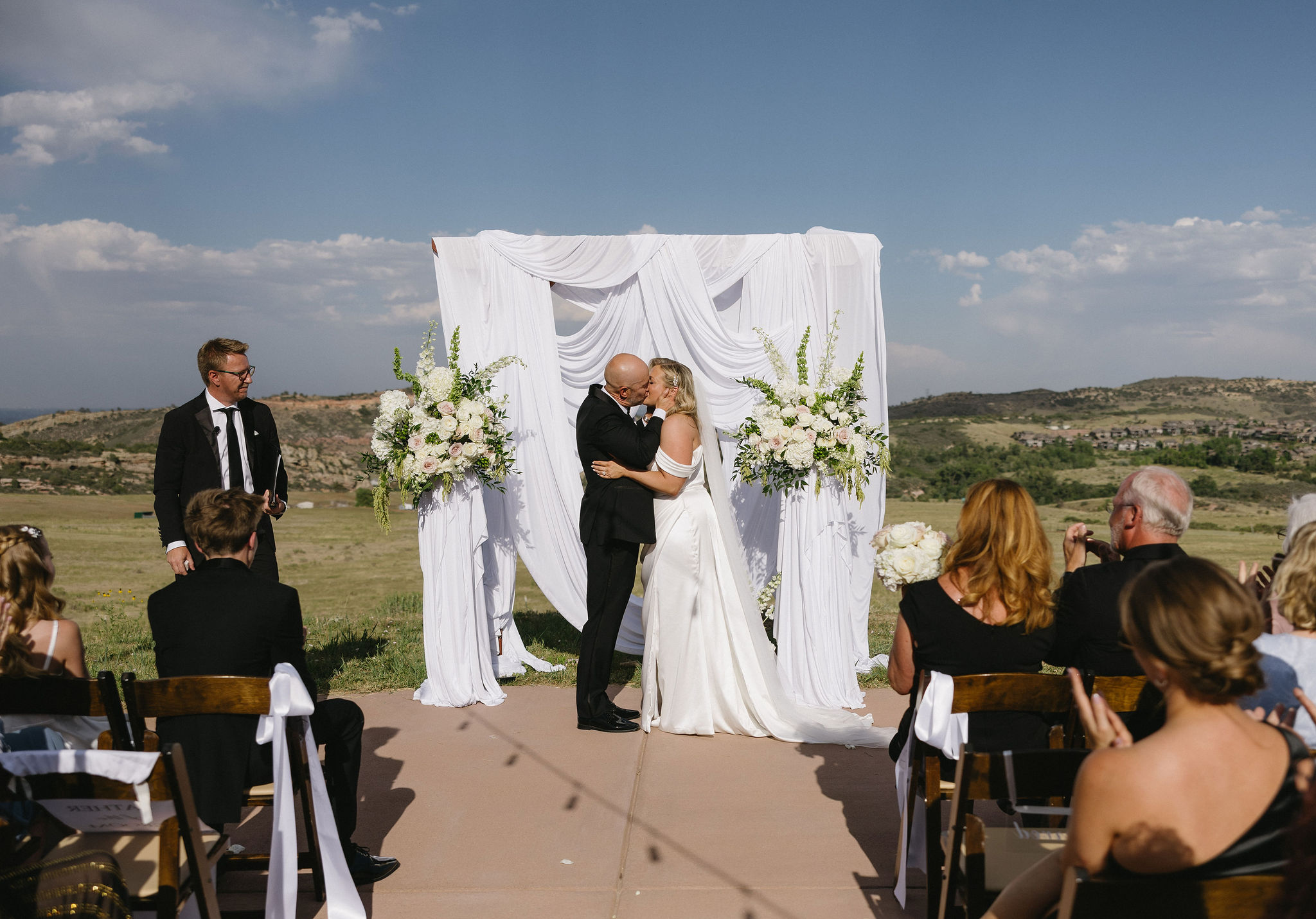 Romantic and Bright wedding ceremony on the helipad outside of The Fort Morrison Colorado Restaurant 