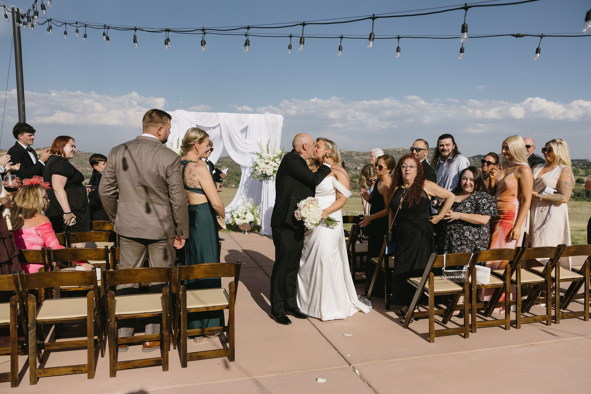 Romantic and Bright wedding ceremony on the helipad outside of The Fort Morrison Colorado Restaurant 