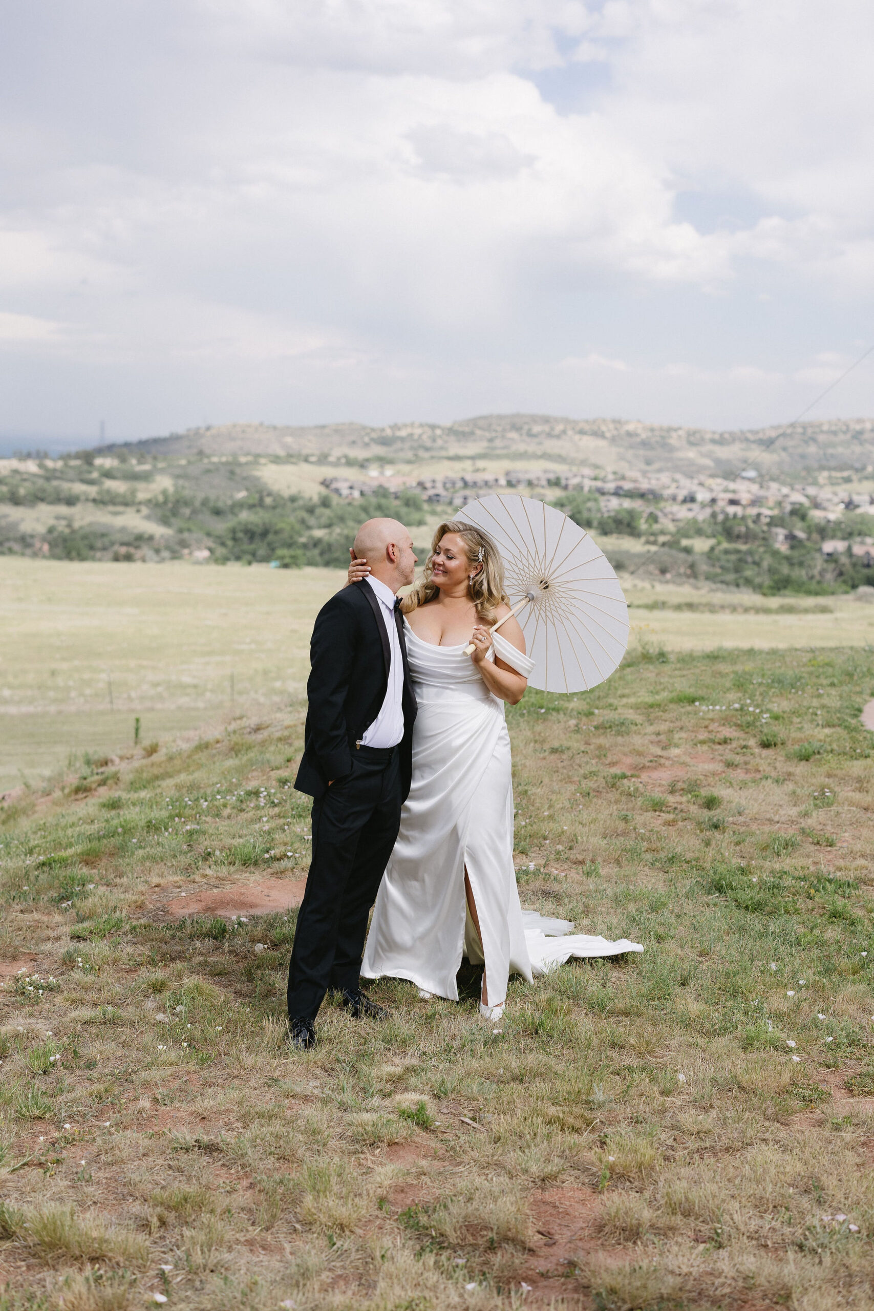 Bride and groom romantic and classy portraits in the bright Colorado sunshine at The Fort Restaurant in Morrison, CO.